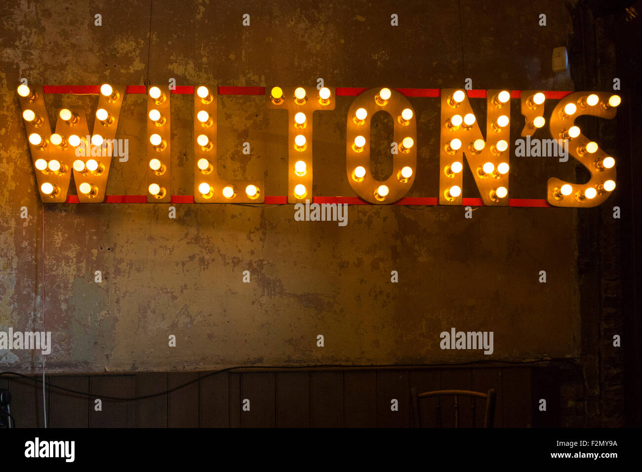 The iconic Wilton's sign in the bar area. Wilton’s Music Hall is one of ...