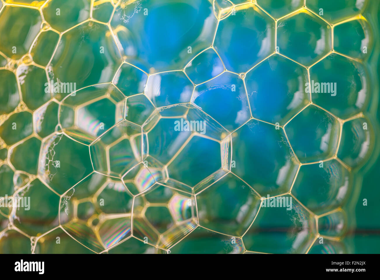 Soap suds extreme closeup creating pattern of golden lines