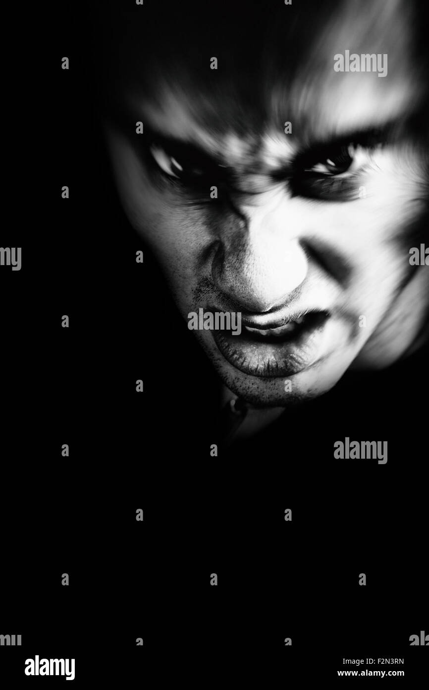 Evil face of scary angry man in the dark Stock Photo