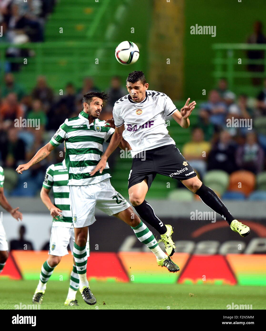 Lisbon, Portugal. 21st Sep, 2015. Sporting's Bryan Ruiz(L) vies with Nacional's player during their 5th round of Portuguese league soccer match at the Alvalade stadium in Lisbon, Portugal, on Sept. 21, 2015. Sporting won 1-0. © Zhang Liyun/Xinhua/Alamy Live News Stock Photo