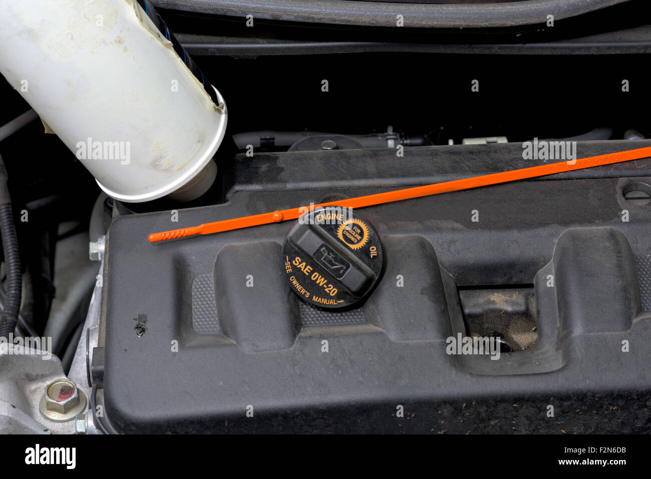 Adding engine oil to a car Stock Photo Alamy