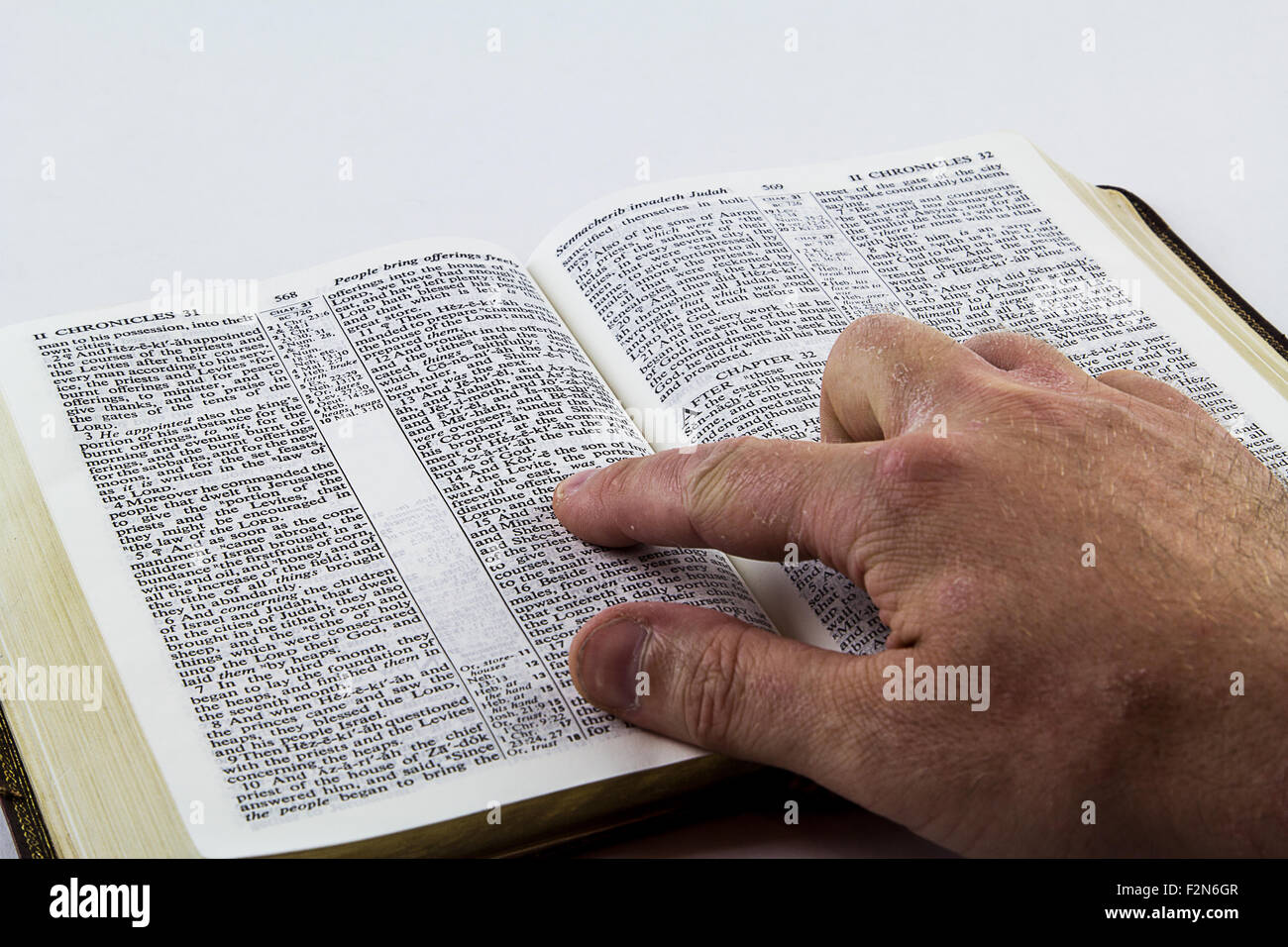 Reading a King James bible on a white background Stock Photo