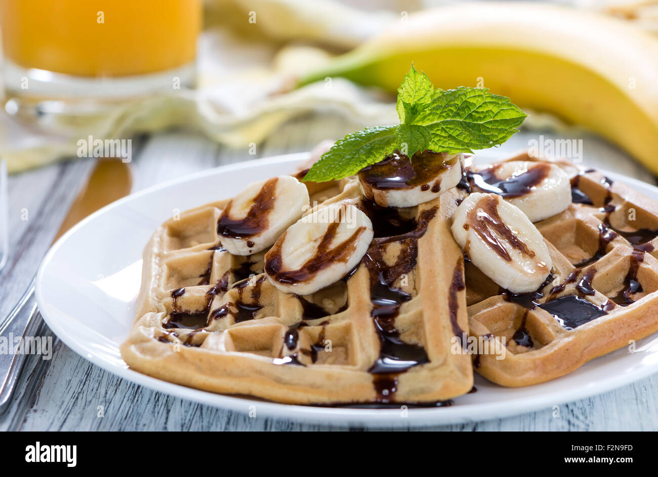Sweet Breakfast (Waffles with Bananas and creamy Chocolate Sauce) Stock Photo