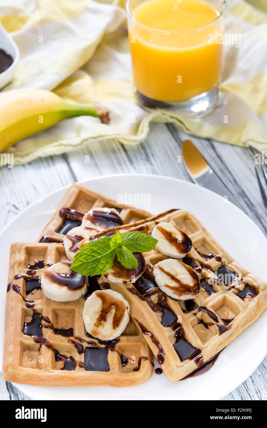 Breakfast table (Waffles with Bananas and Chocolate Sauce as close-up ...