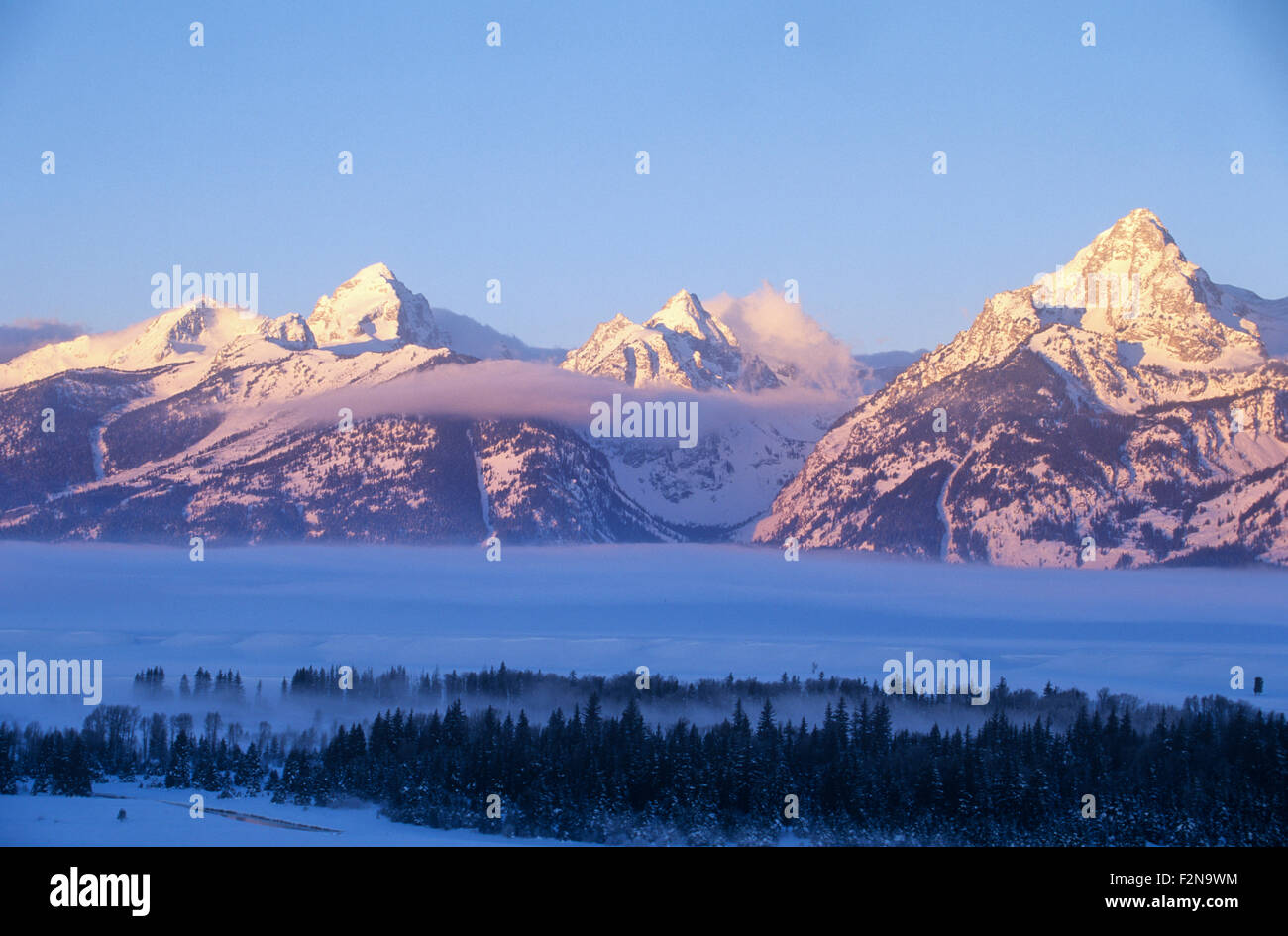 The Teton mountain range at dawn in winter, Grand Teton National Park, Wyoming, USA. Stock Photo