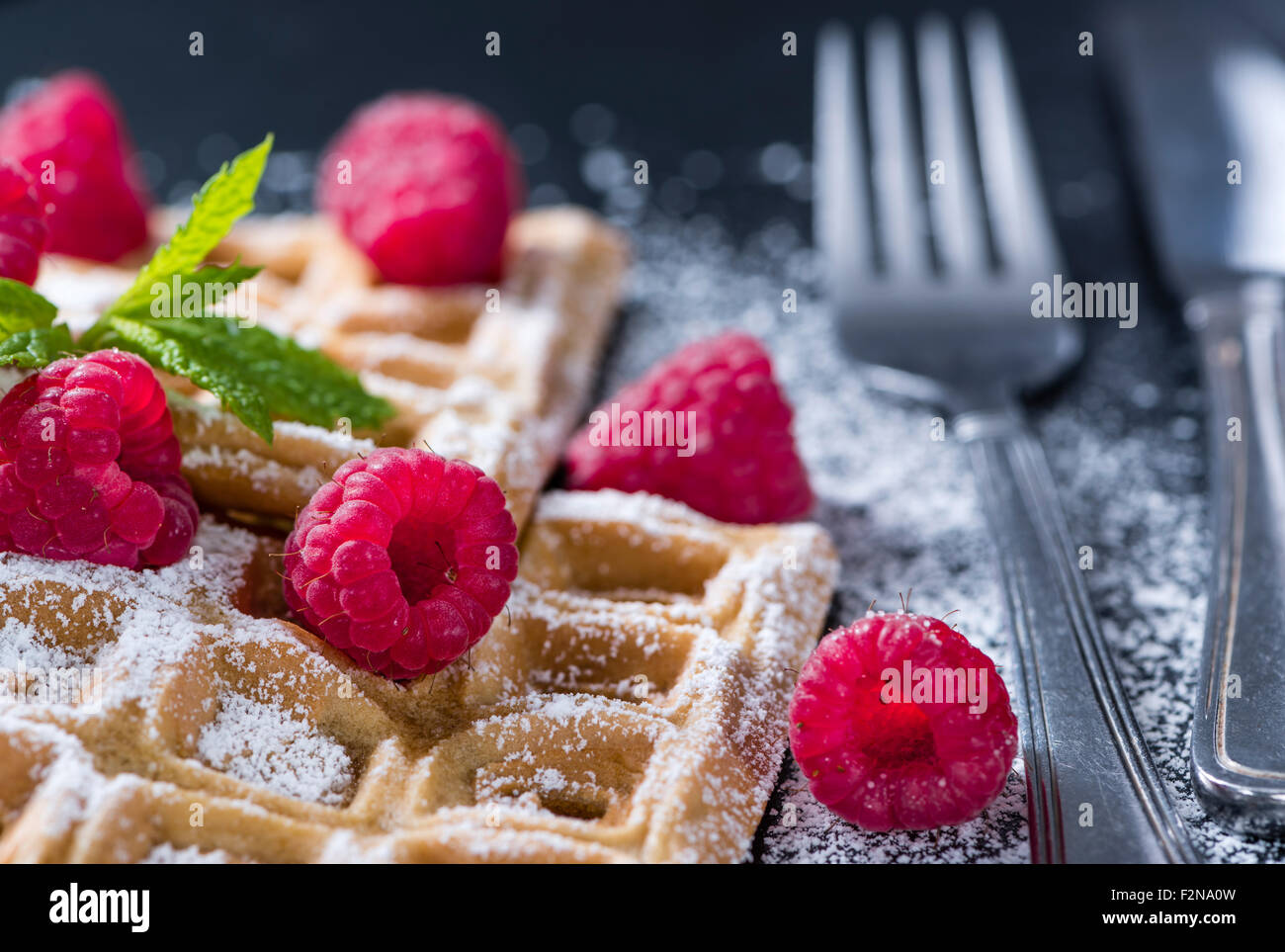 Homemade Waffles with Raspberries and powder sugar (close-up shot) Stock Photo
