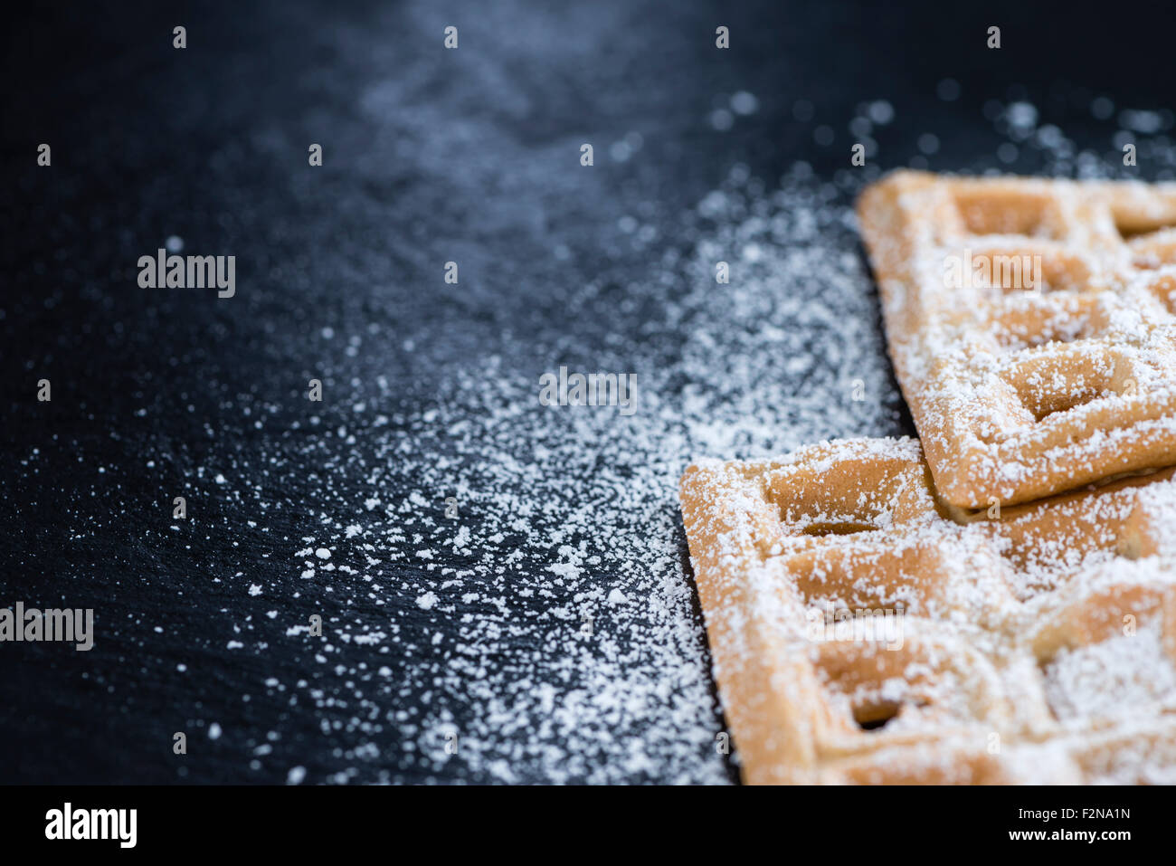 Fresh made Waffles with powder sugar (close-up shot) Stock Photo