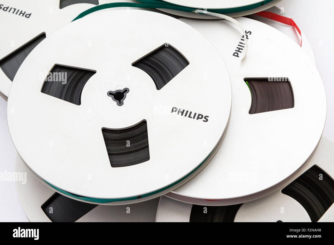 Several Philips reel to reel magnetic tape reels in a scattered pile. Close  up. Reel tape leads in red and green. Philips logo on reels Stock Photo -  Alamy