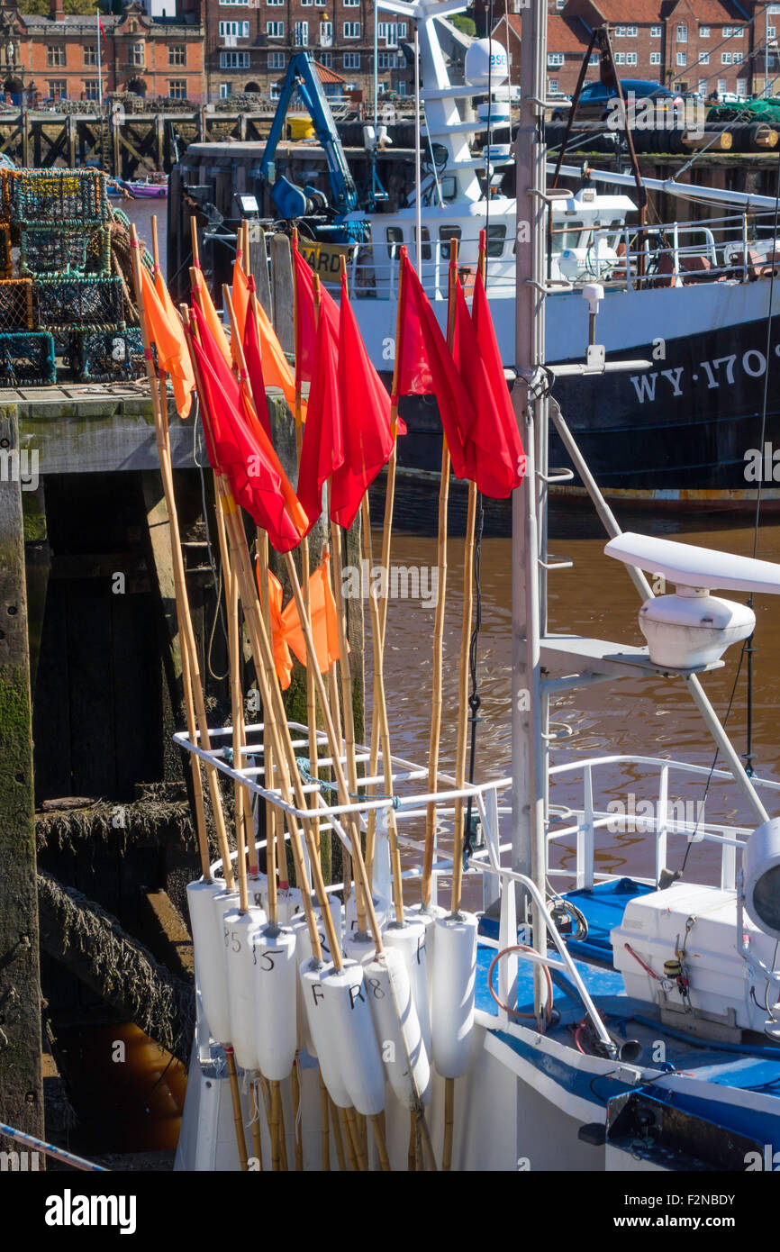 Red flags on marker buoys used for locating crab and lobster pots by professional fishermen Stock Photo