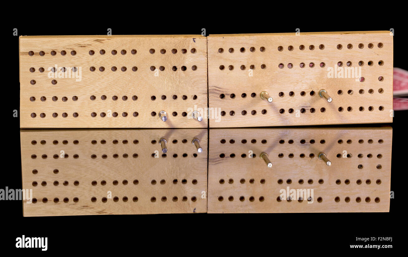 Cribbage board closeup with holes and pegs Stock Photo Alamy