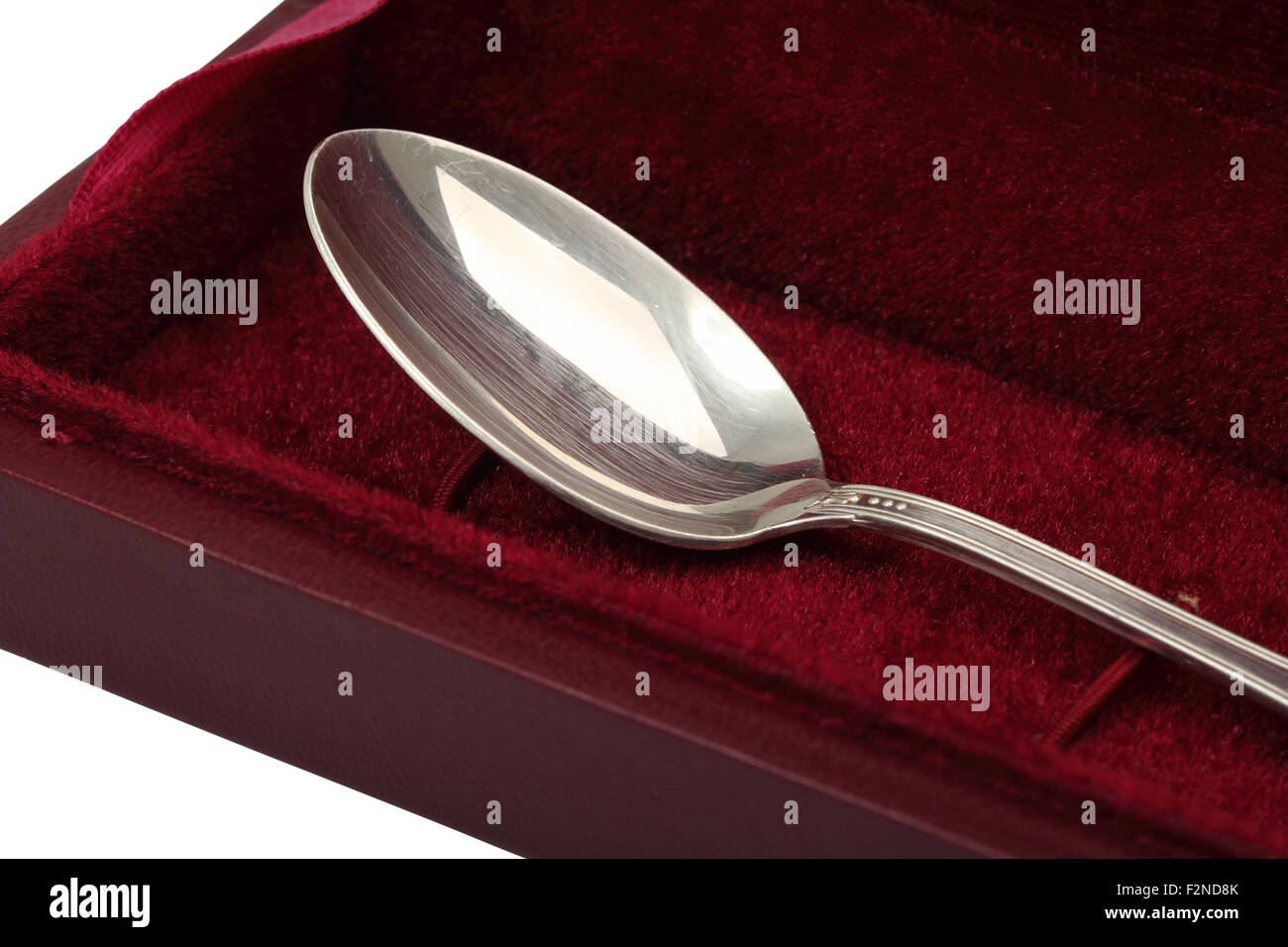 Silver spoon in box. Isolated with clipping path. Stock Photo