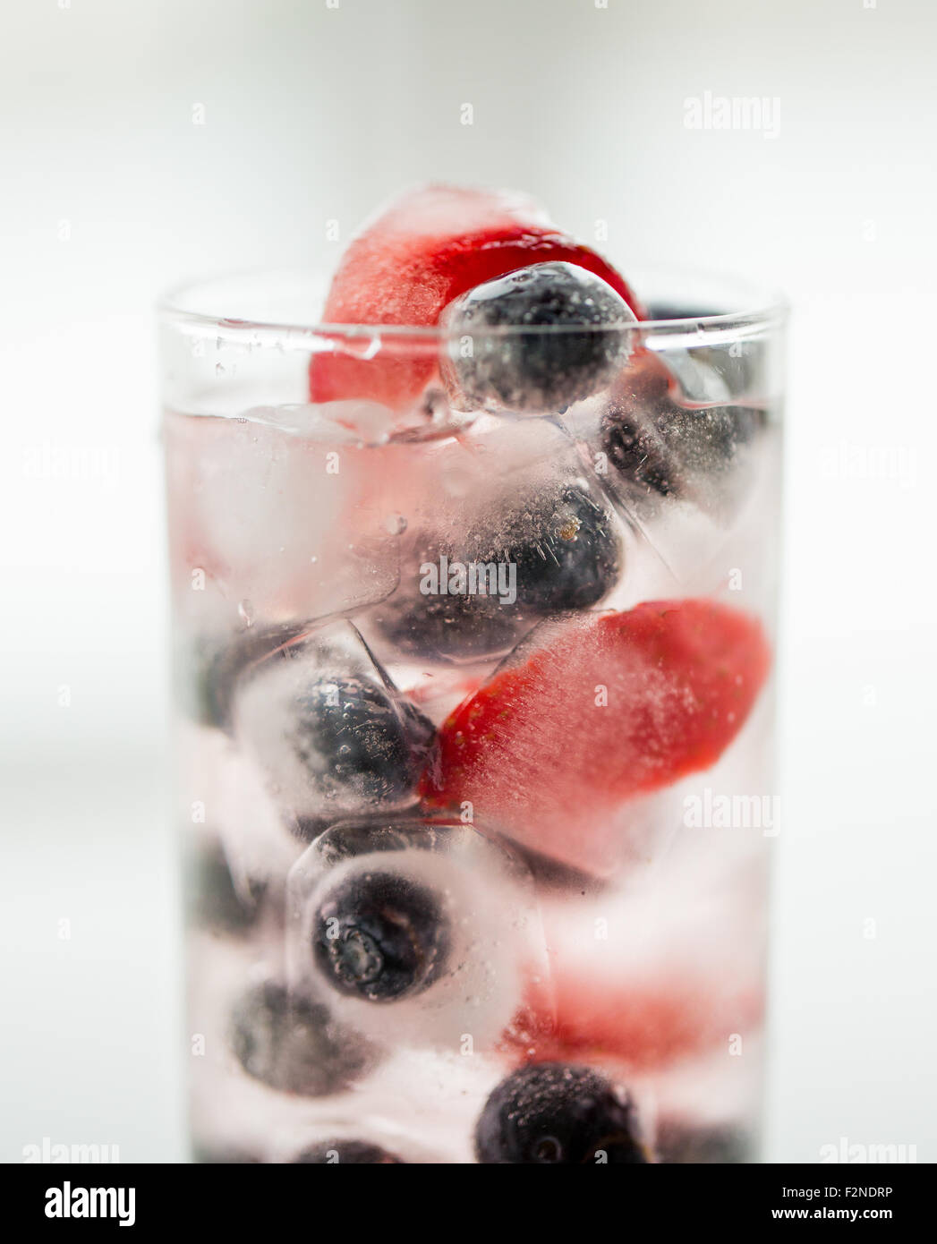 close up of fruit water with ice cubes in glass Stock Photo - Alamy