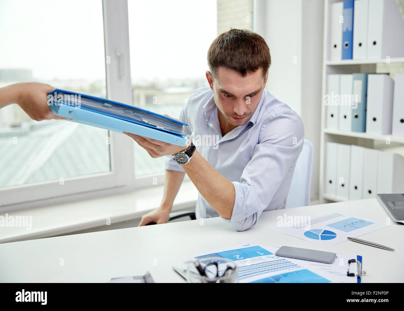 businessman taking papers from secretary in office Stock Photo - Alamy