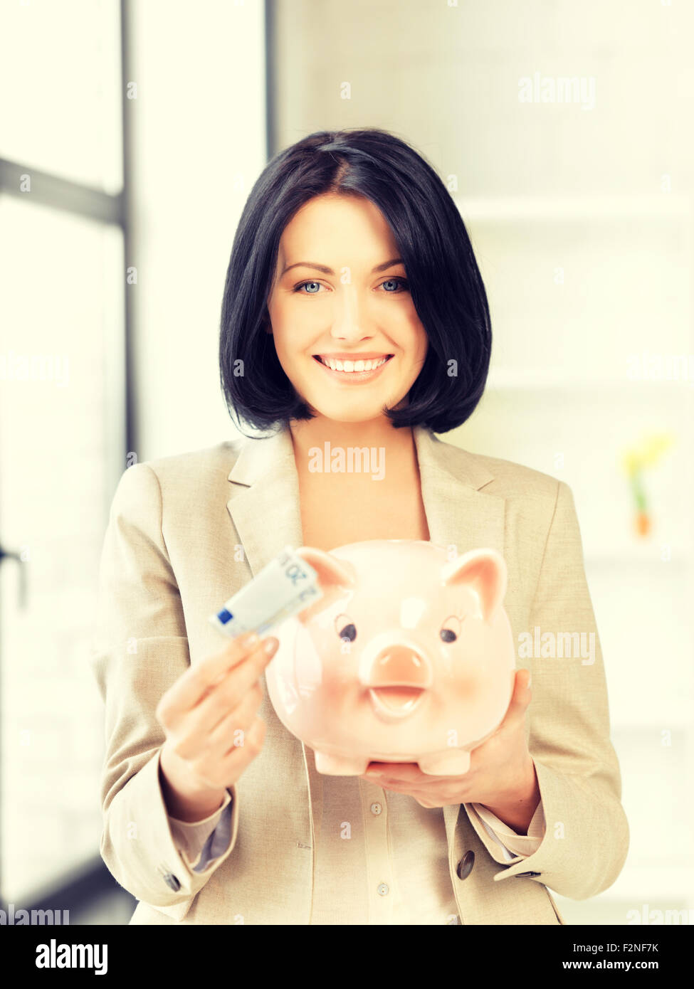 lovely woman with piggy bank and money Stock Photo - Alamy