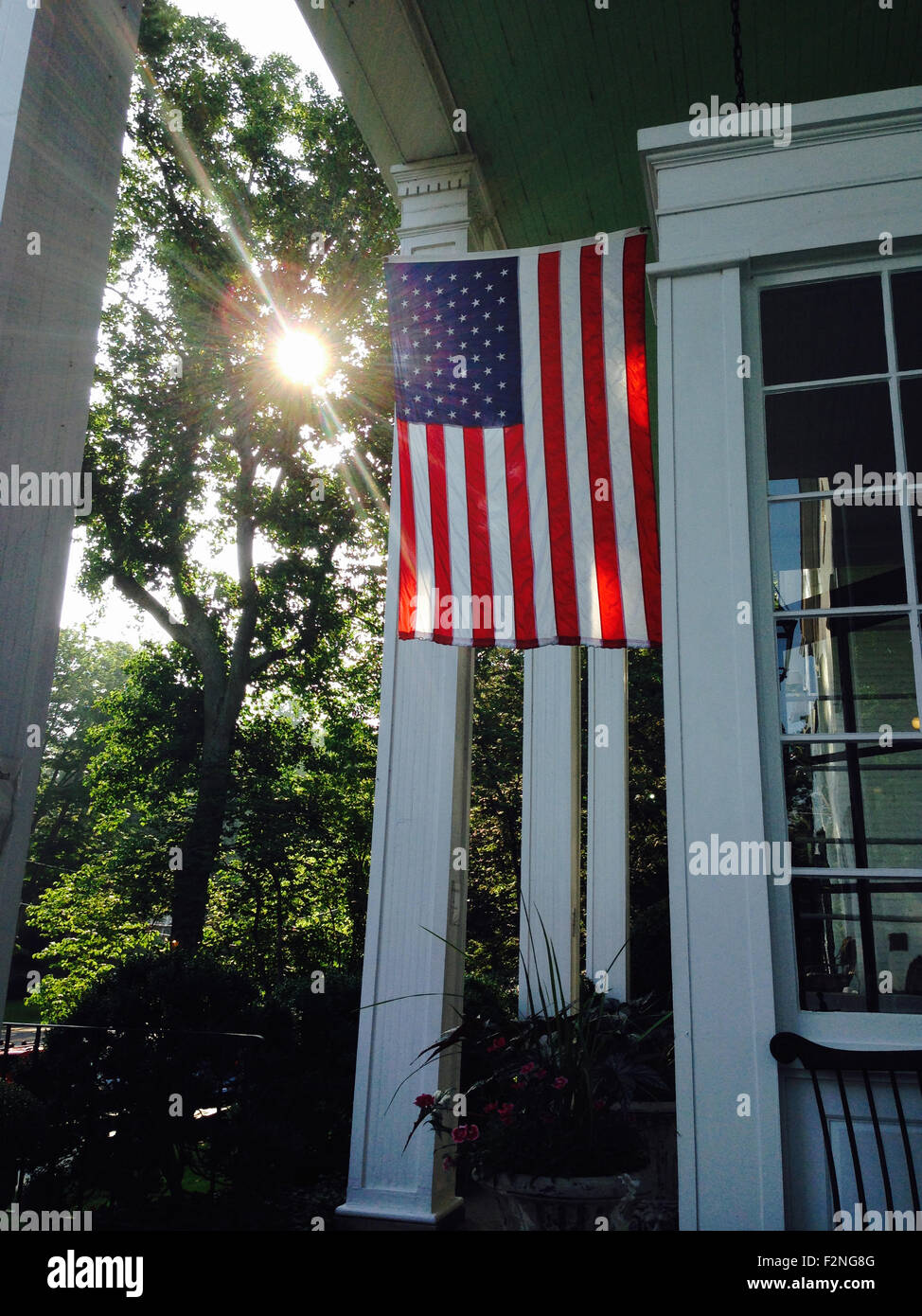 American flag hanging from house - Smartphone Captured Stock Image
