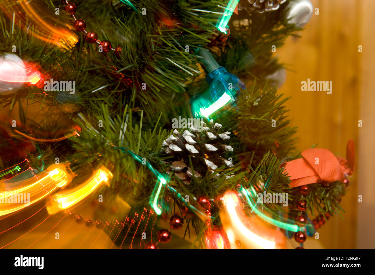 A zoomed image of traditional lights on a pine christmas tree Stock