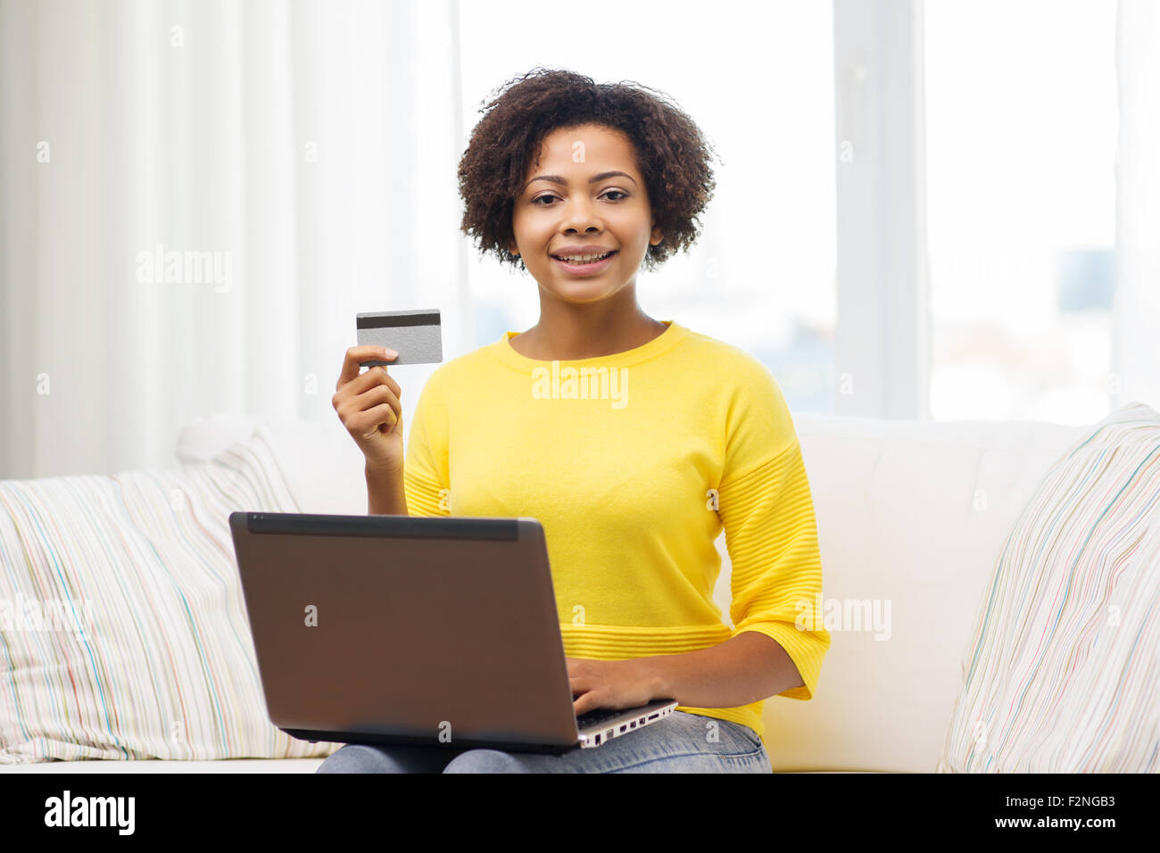 happy african woman with laptop and credit card Stock Photo - Alamy