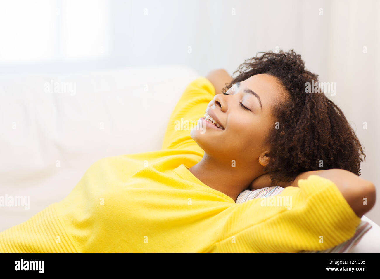 happy african young woman relaxing at home Stock Photo - Alamy