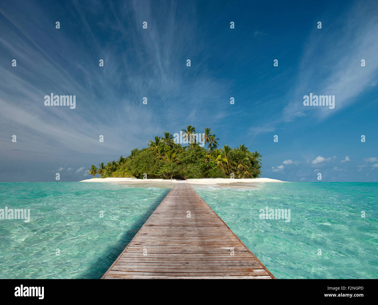 Wooden dock walkway to tropical island Stock Photo