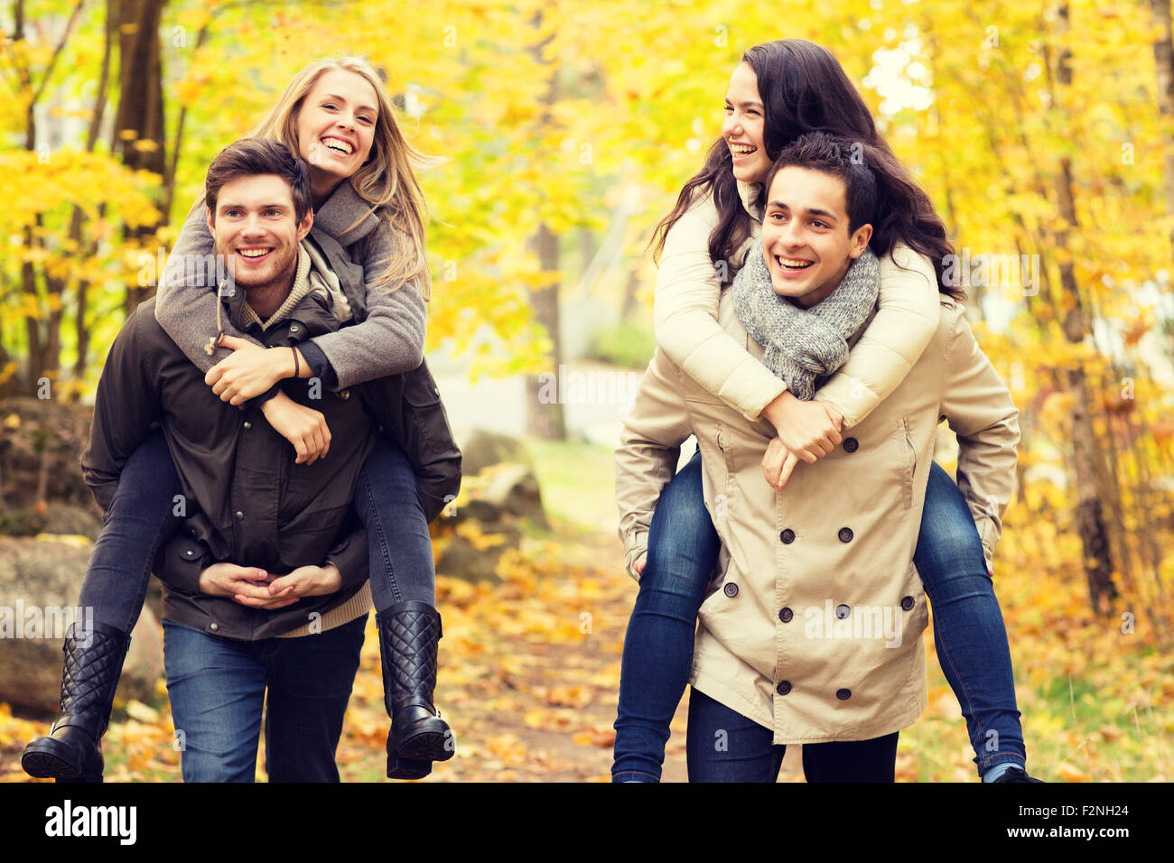 smiling friends having fun in autumn park Stock Photo - Alamy