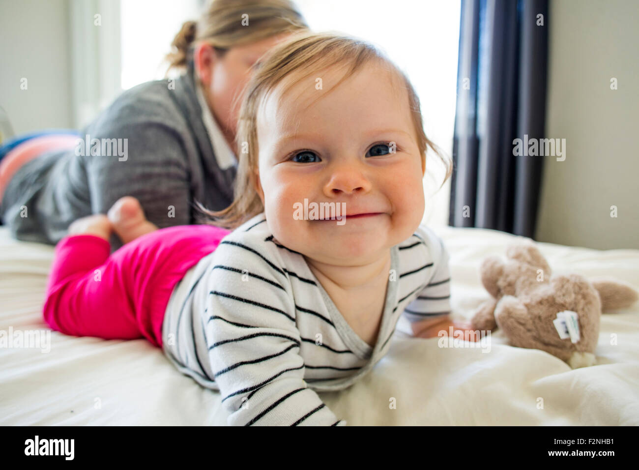 Mother laying with child hires stock photography and images Alamy