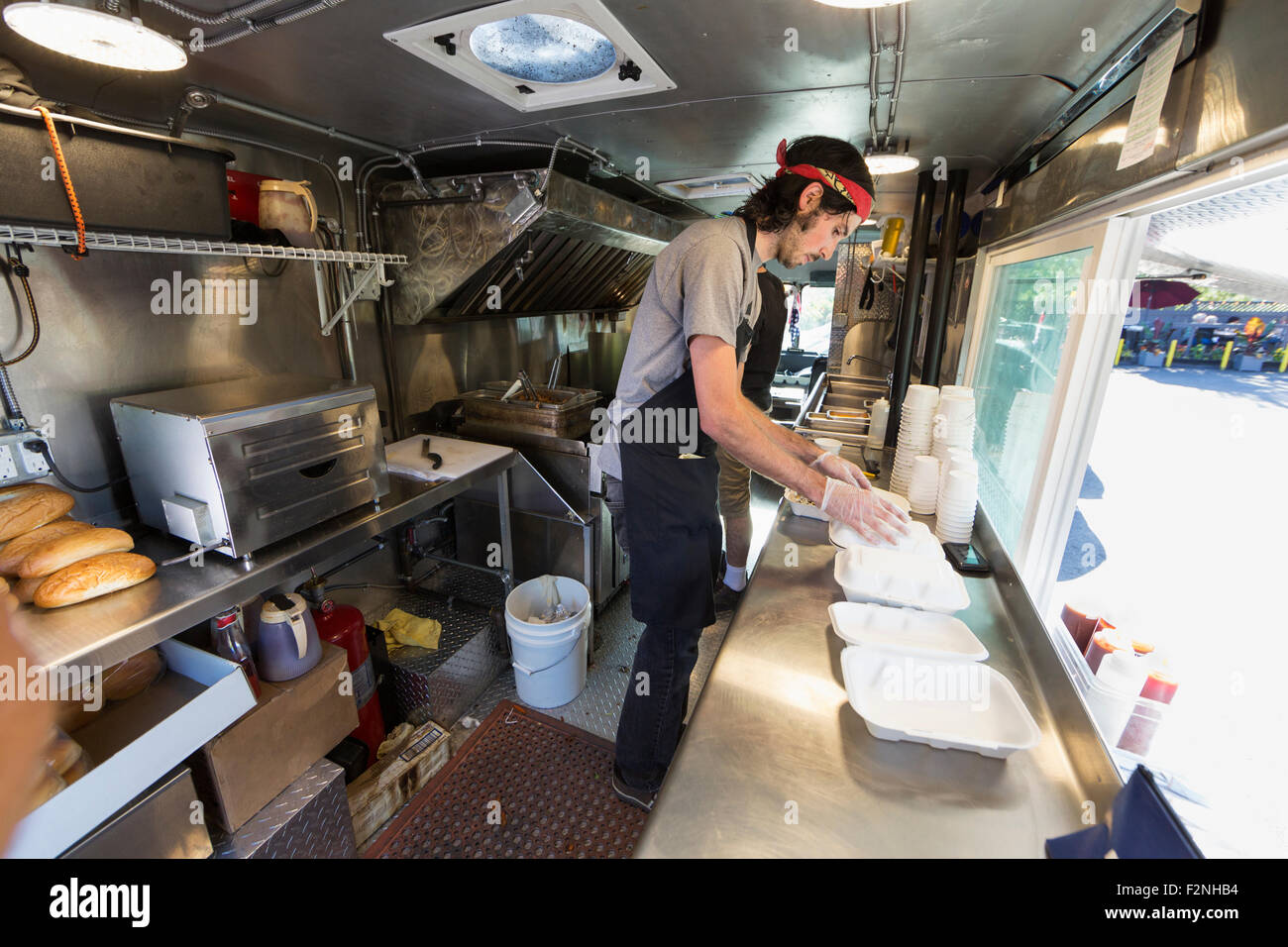 Caucasian chef working in food truck kitchen Stock Photo