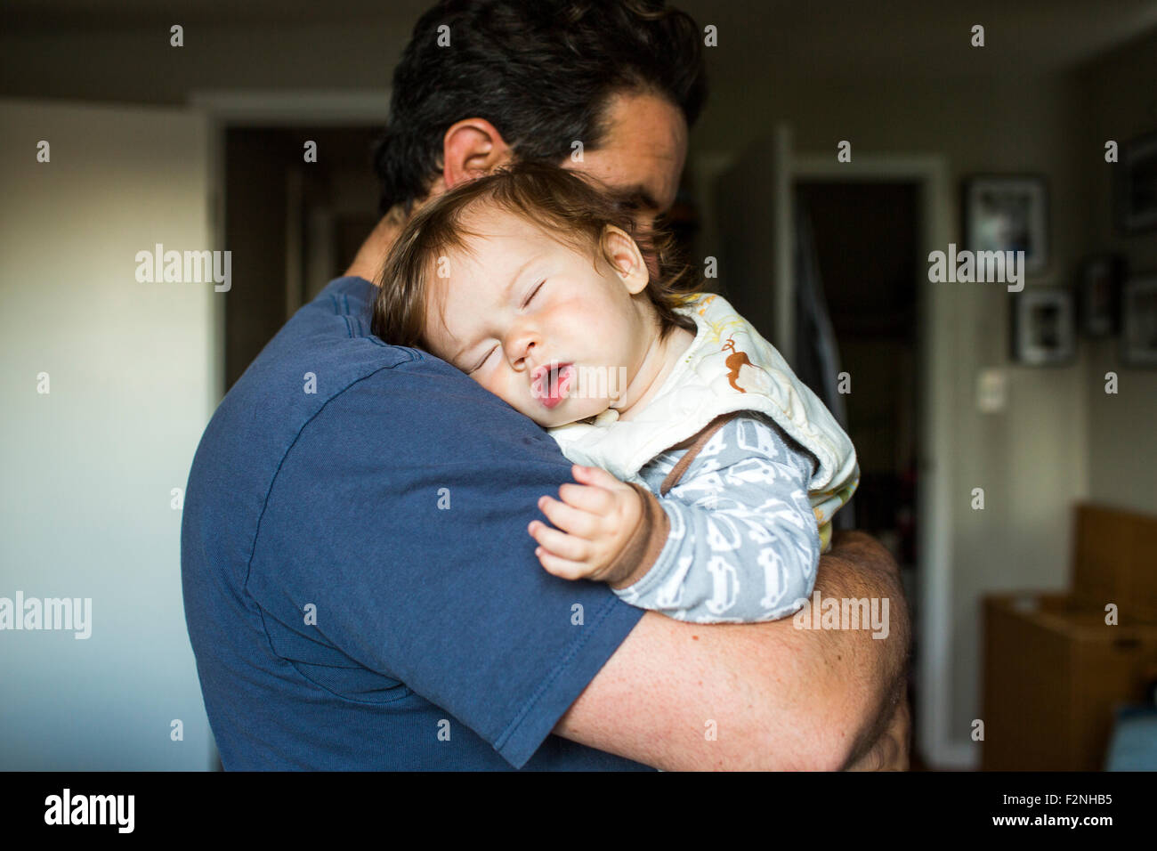 Caucasian father holding sleeping baby girl Stock Photo