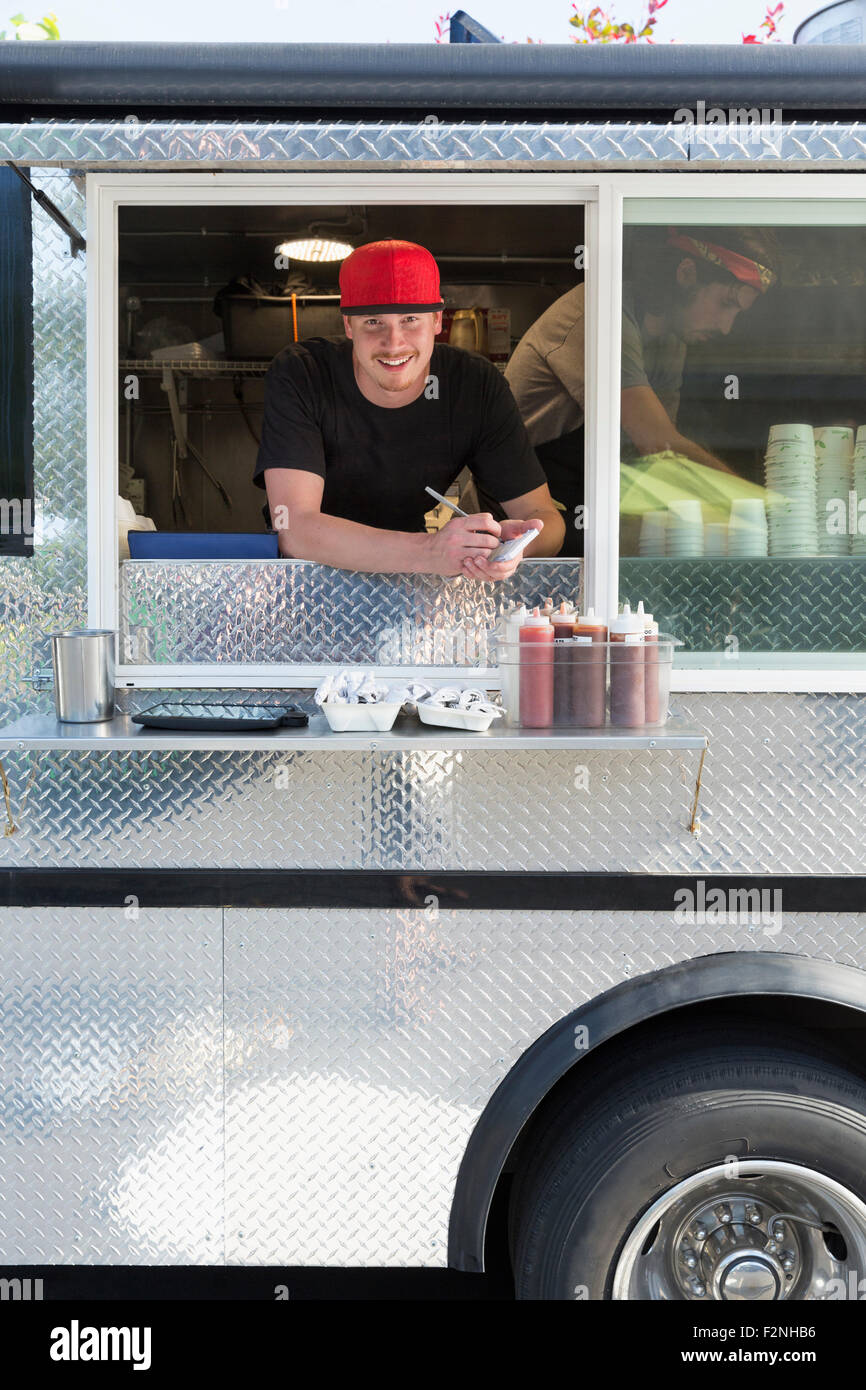 Caucasian man working in food truck Stock Photo