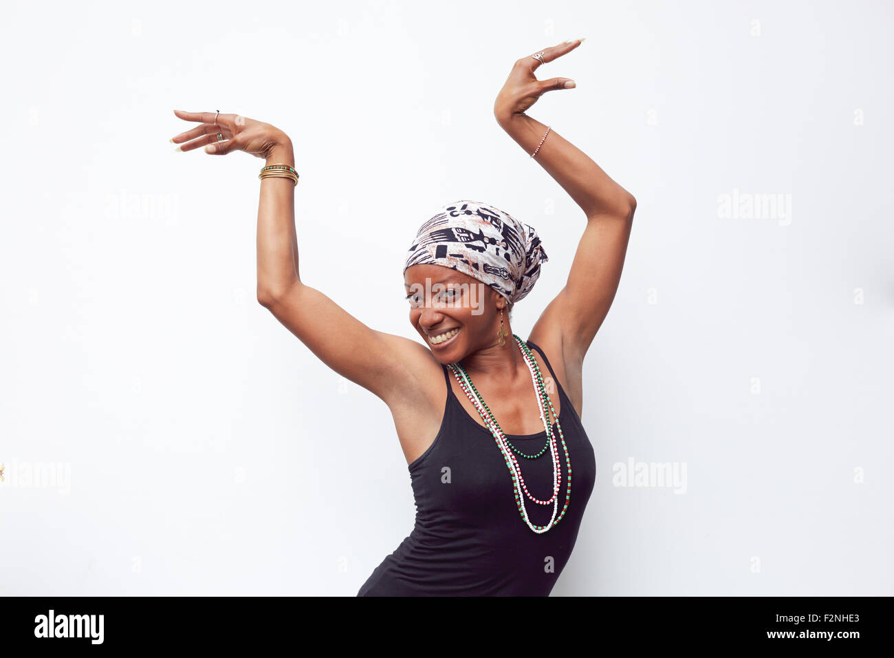 Black woman posing with arms raised Stock Photo