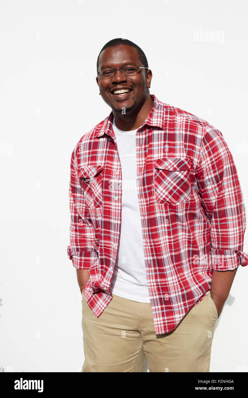 Black man standing with hands in pockets Stock Photo