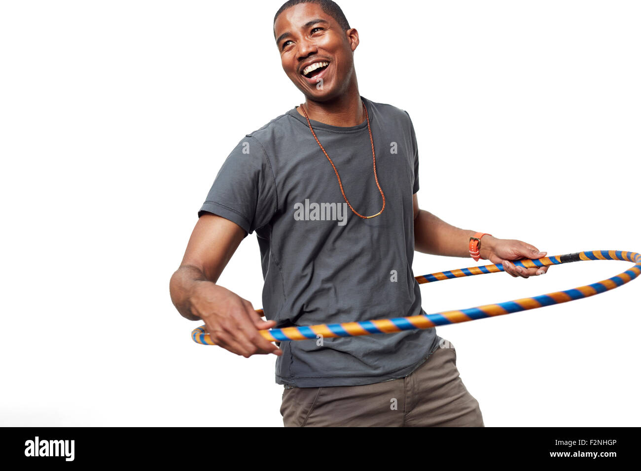 Smiling man playing with plastic hoop Stock Photo