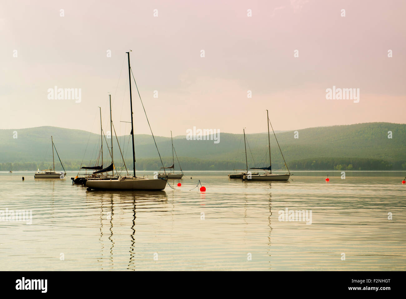 Boats floating in harbor Stock Photo - Alamy