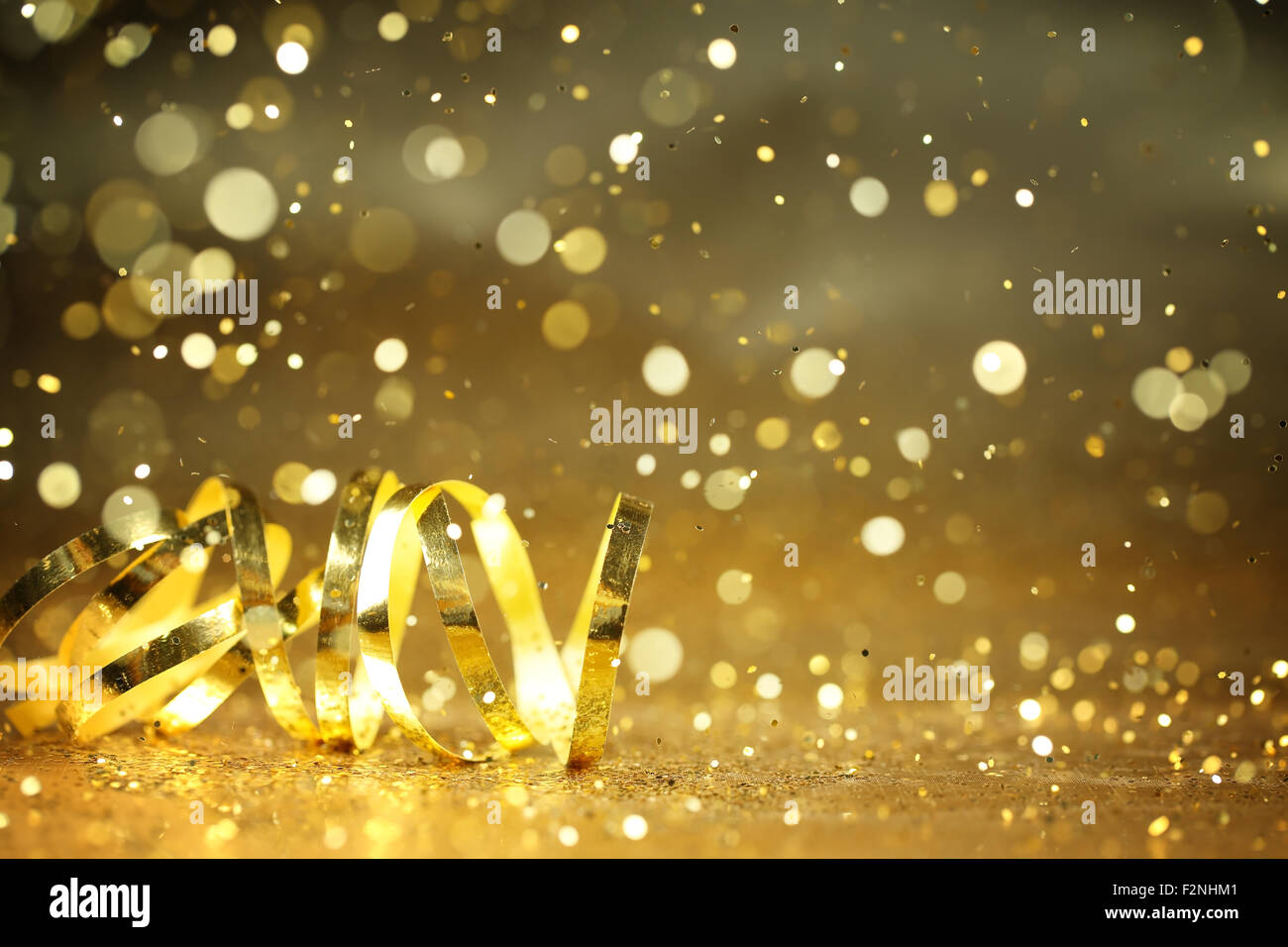Golden streamers and glitter confetti,Closeup. Stock Photo