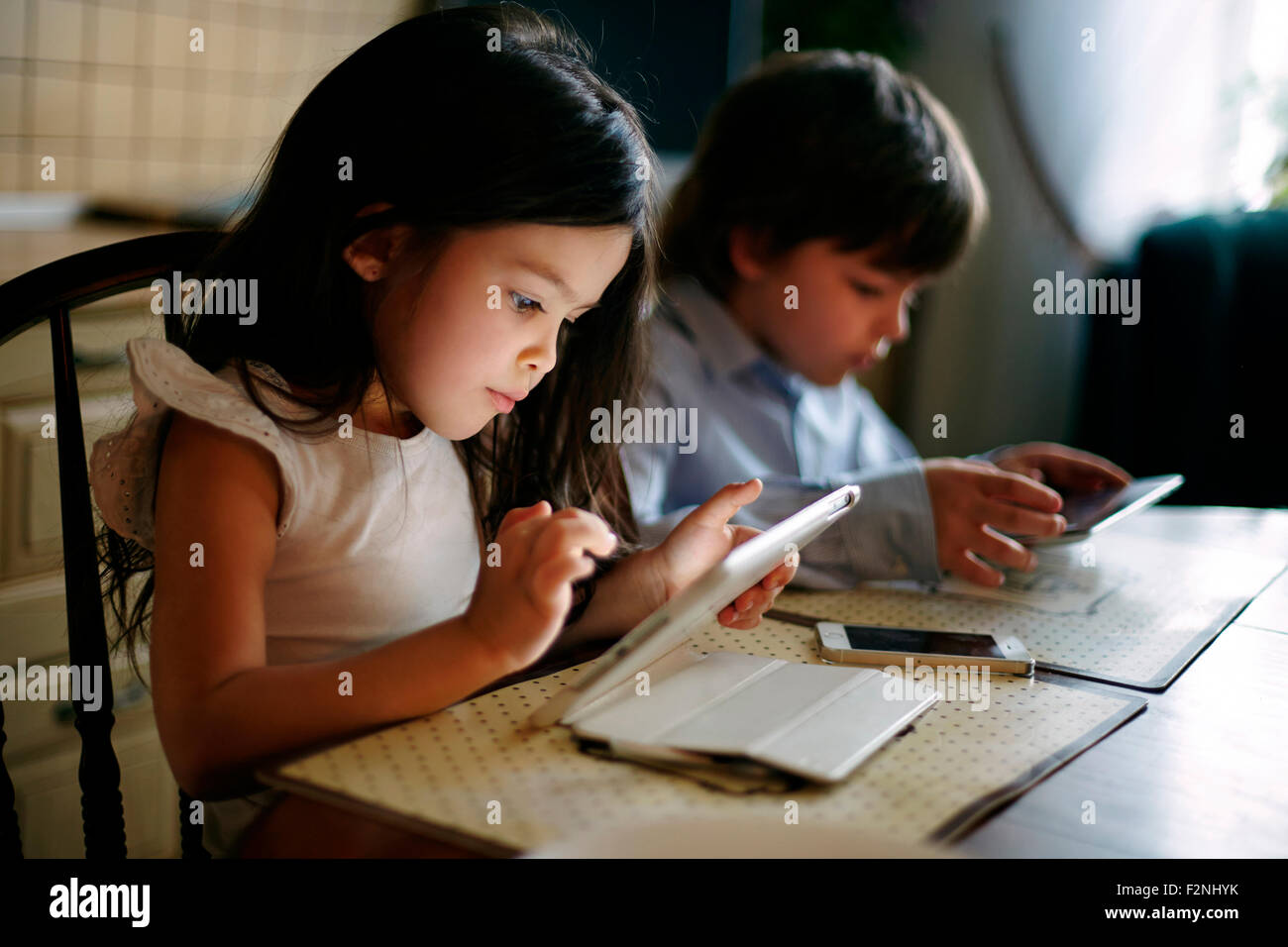 Caucasian brother and sister using digital tablets Stock Photo - Alamy