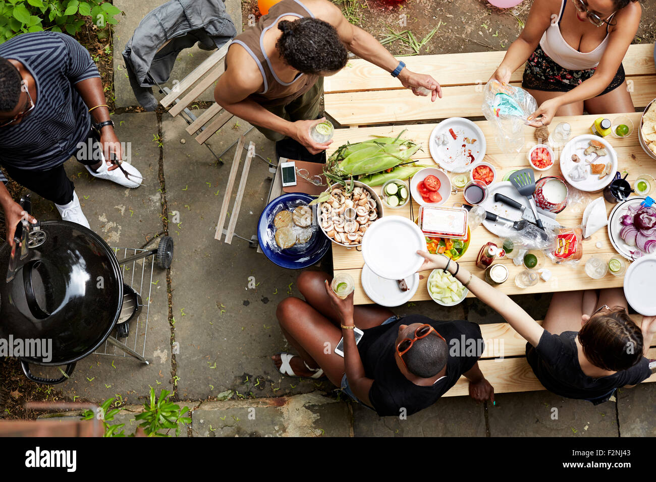 High angle view of friends eating at backyard barbecue Stock Photo