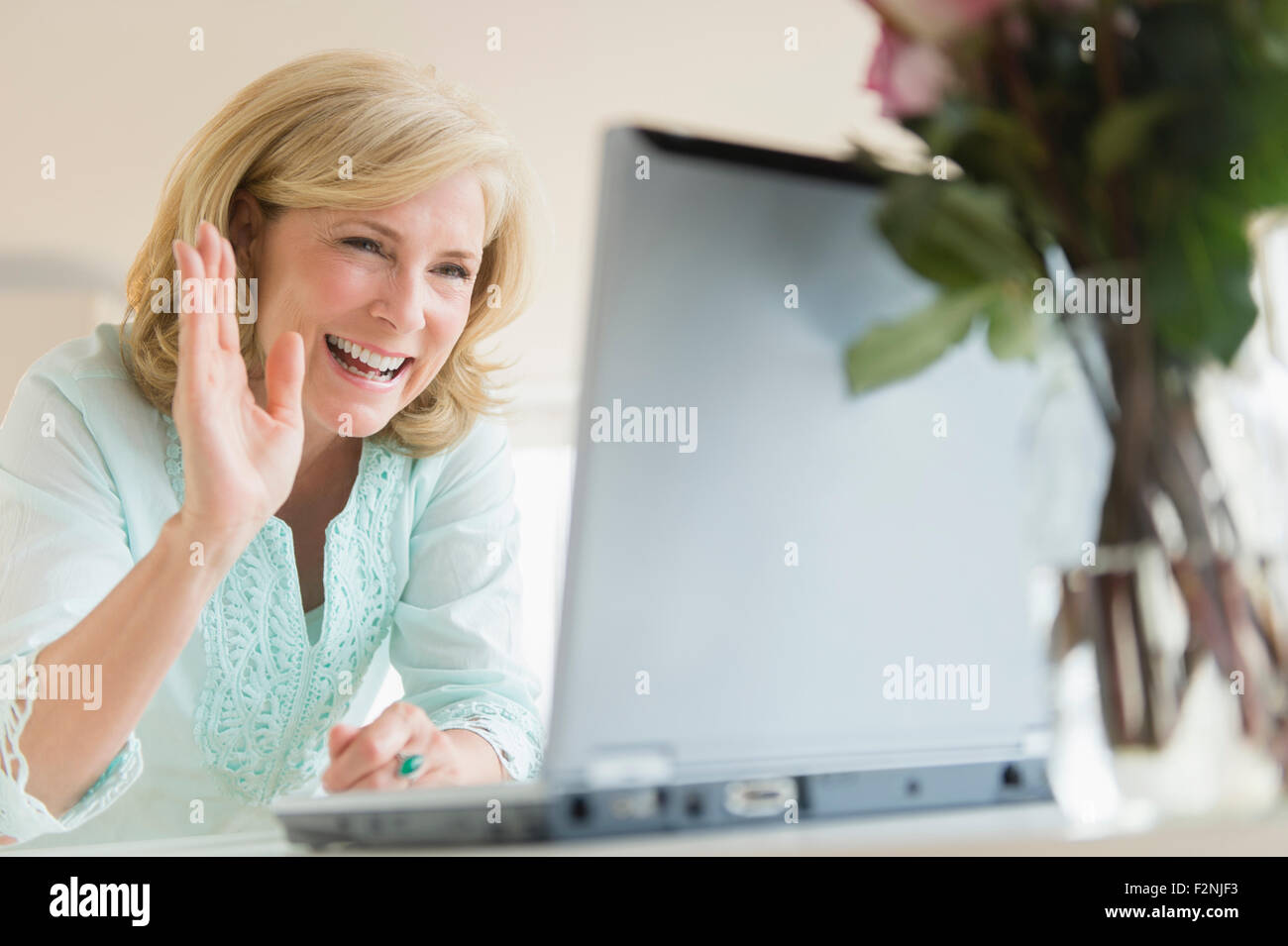 Caucasian woman video chatting on laptop Stock Photo