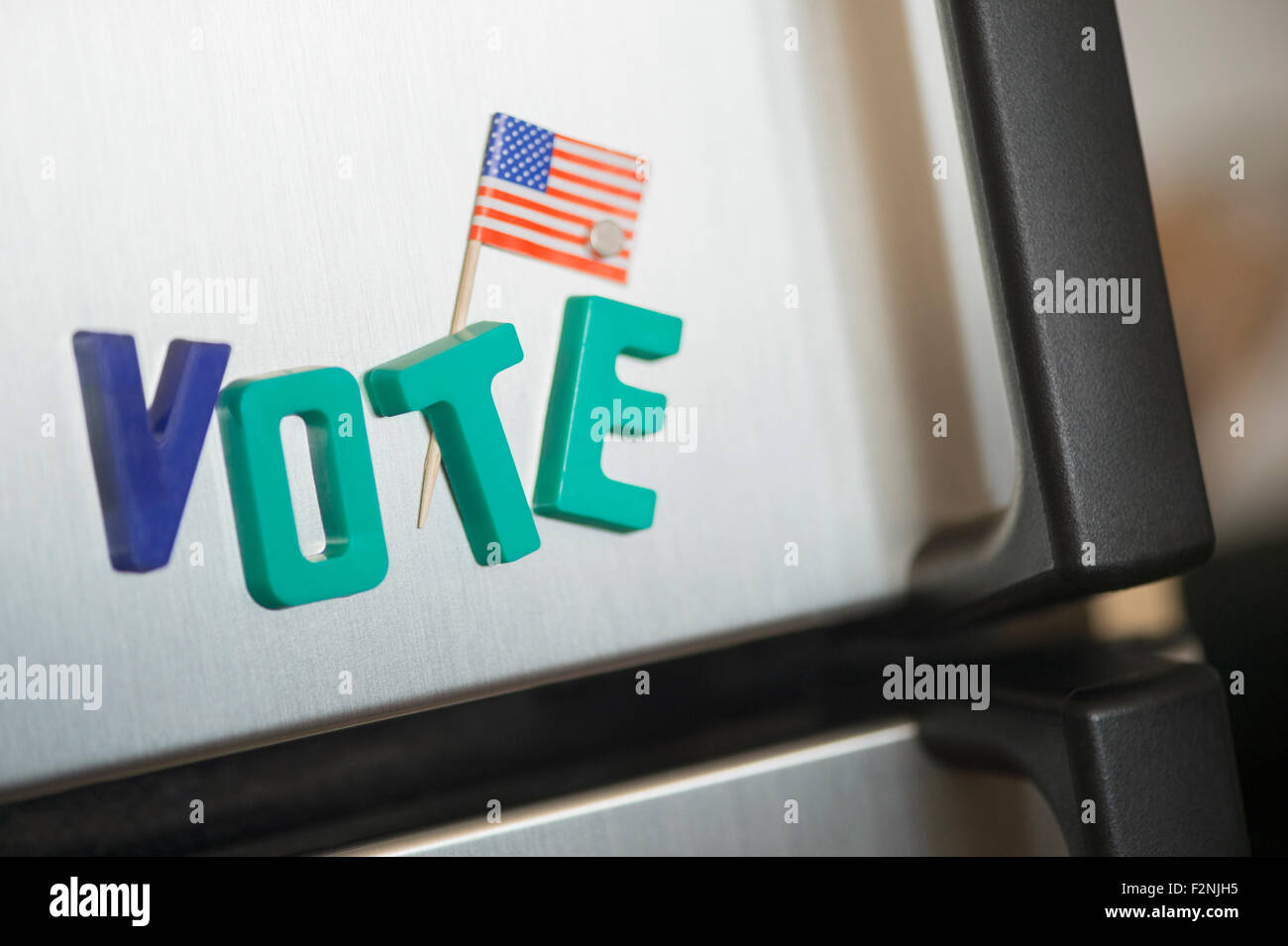 Close up of vote magnets and American flag on refrigerator Stock Photo