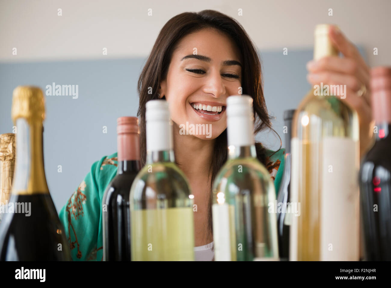 Woman choosing bottle of wine Stock Photo