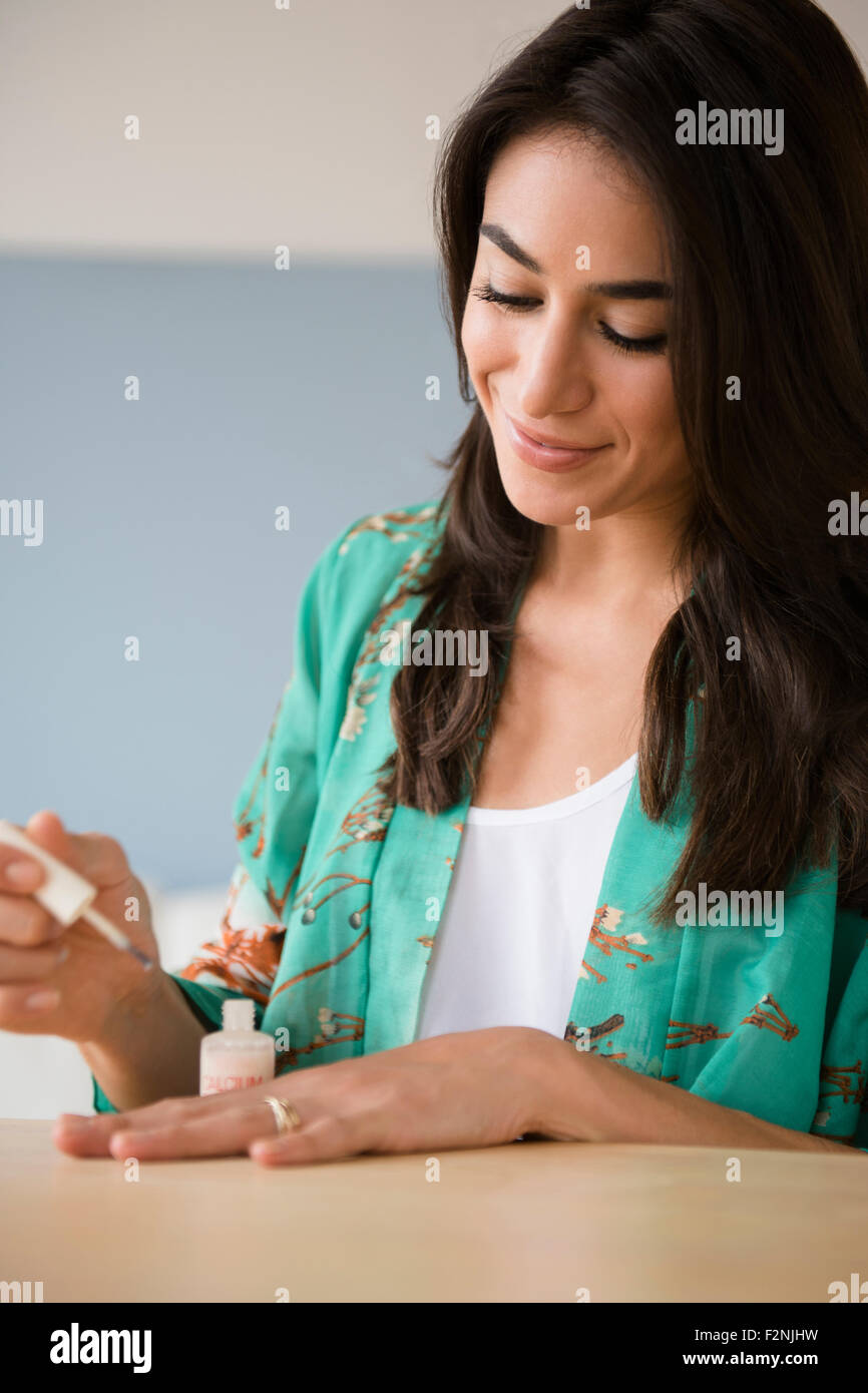 Close up of woman painting her fingernails Stock Photo