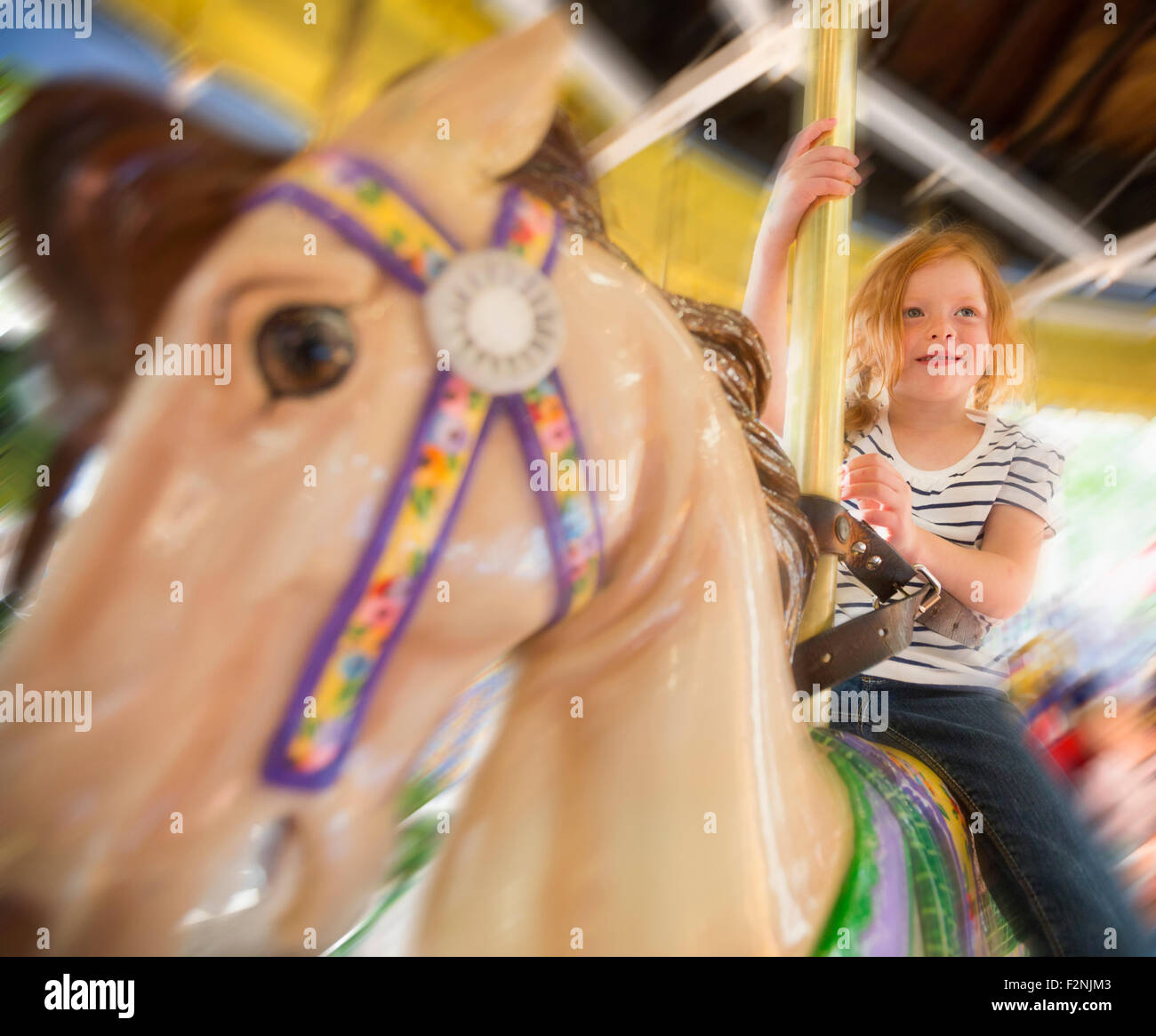 Girl riding on merry go round hires stock photography and images Alamy