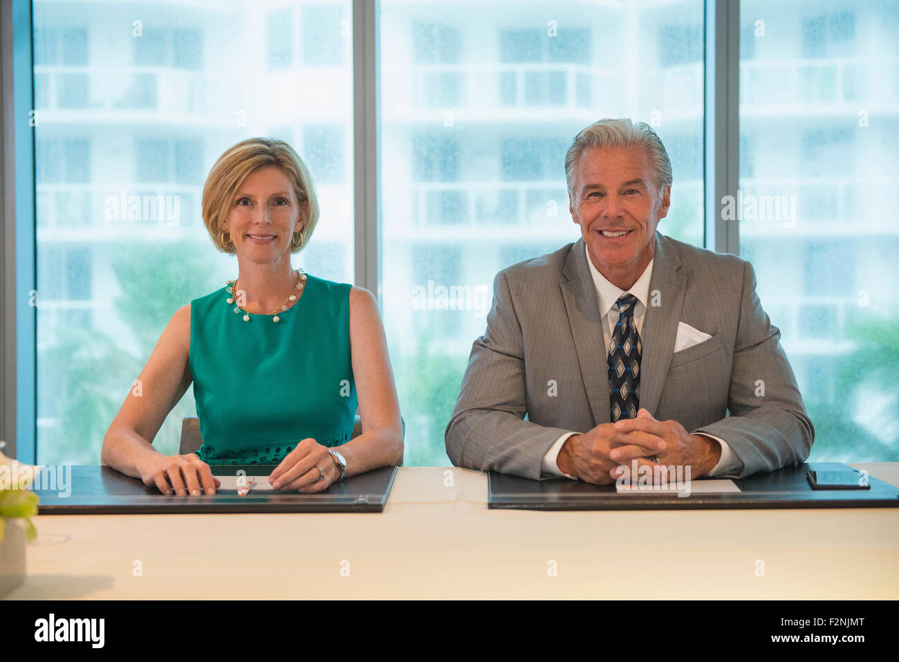 Caucasian business people smiling in meeting Stock Photo