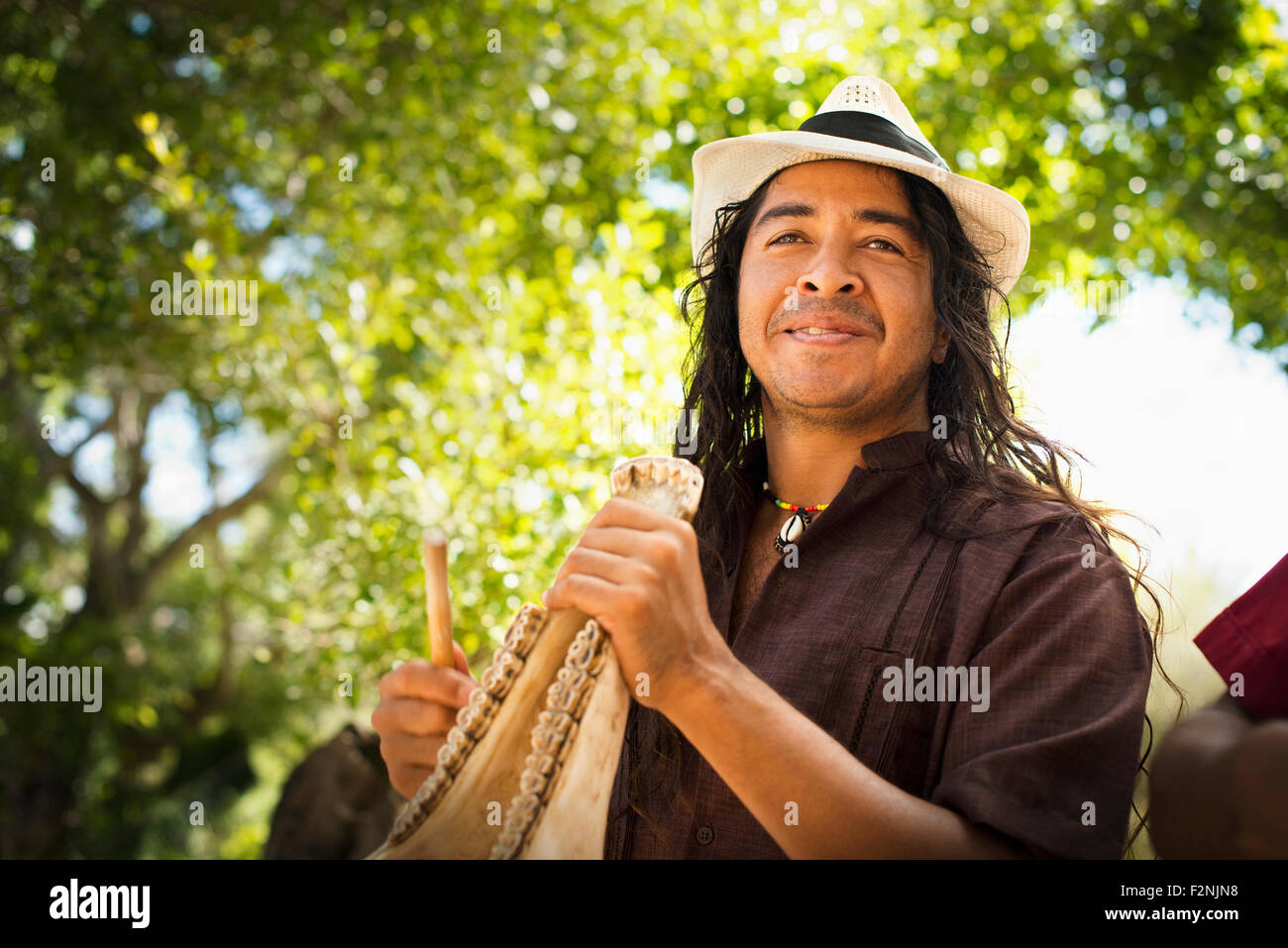 Musician performing in park Stock Photo