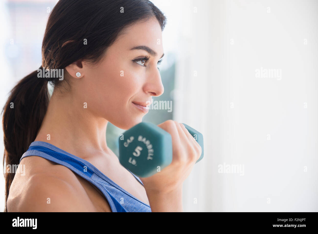 Woman lifting weights Stock Photo
