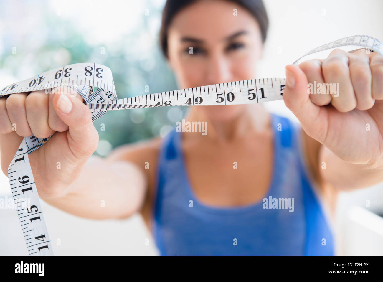 Woman holding measuring tape Stock Photo