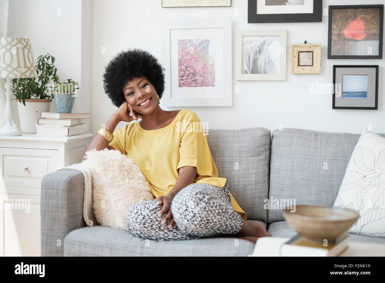 African American woman relaxing on sofa Stock Photo - Alamy