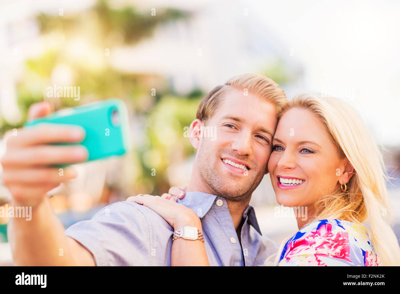 Caucasian couple taking selfie on cell phone Stock Photo - Alamy
