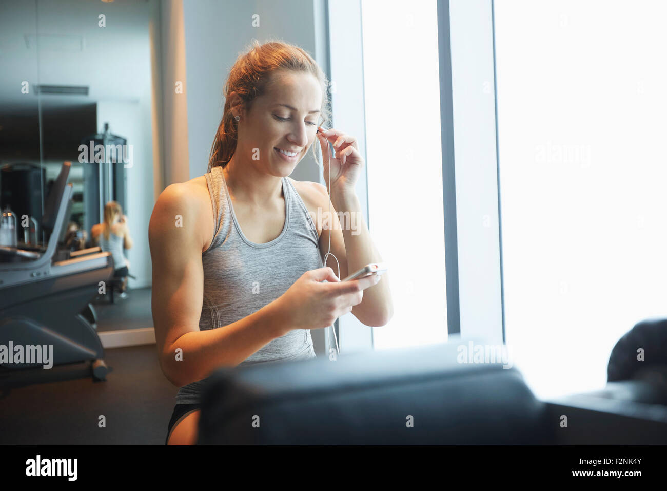Woman listening to mp3 player in gym Stock Photo