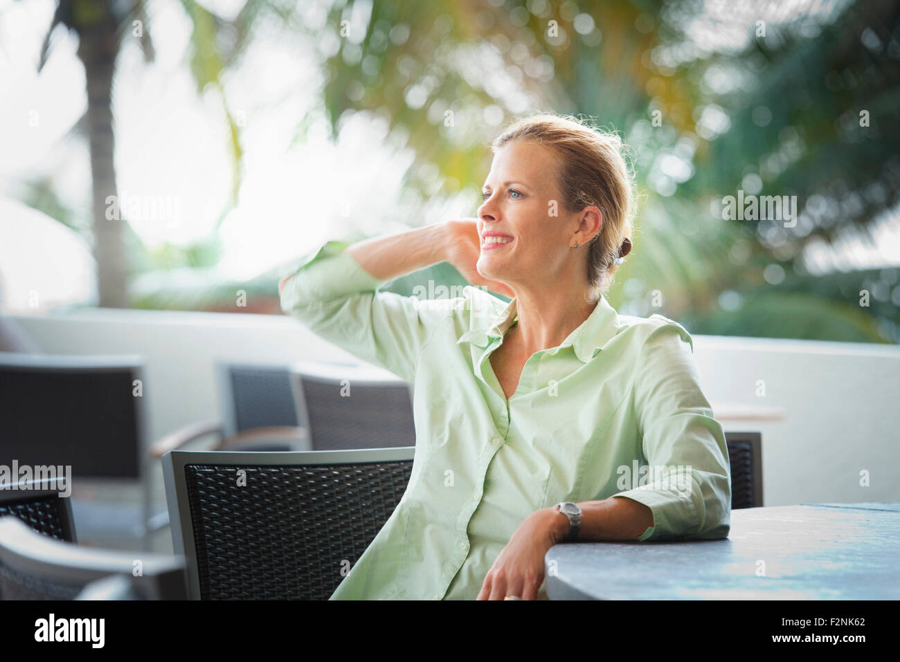 Woman sitting at patio bar Stock Photo