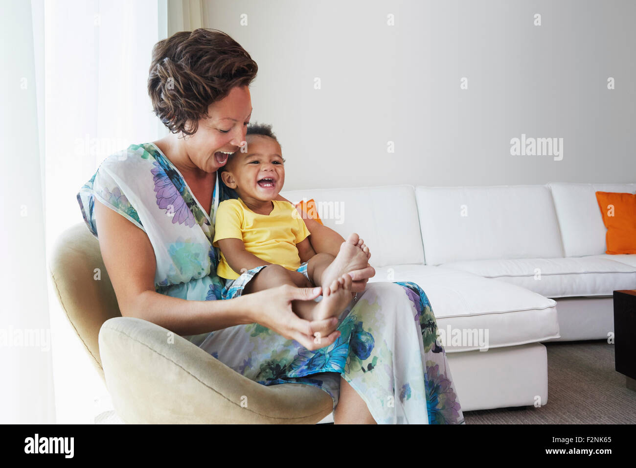 Black mother and son sitting in living room Stock Photo