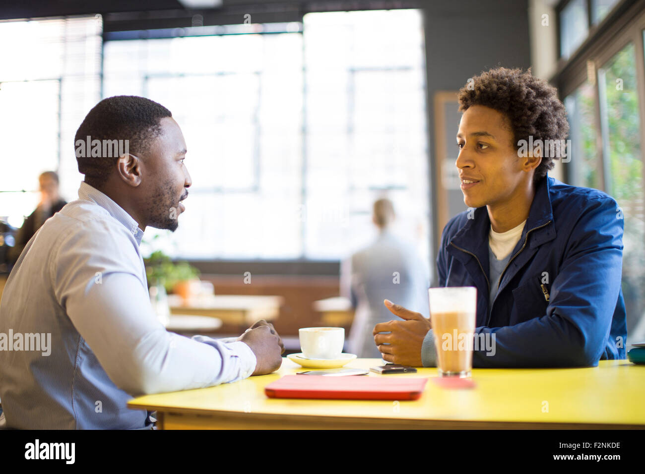 Men drinking coffee in cafe Stock Photo